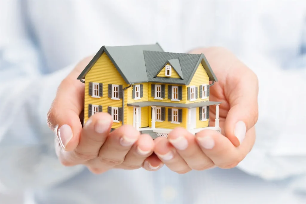 hands holding a house, a representation of a mortgage
